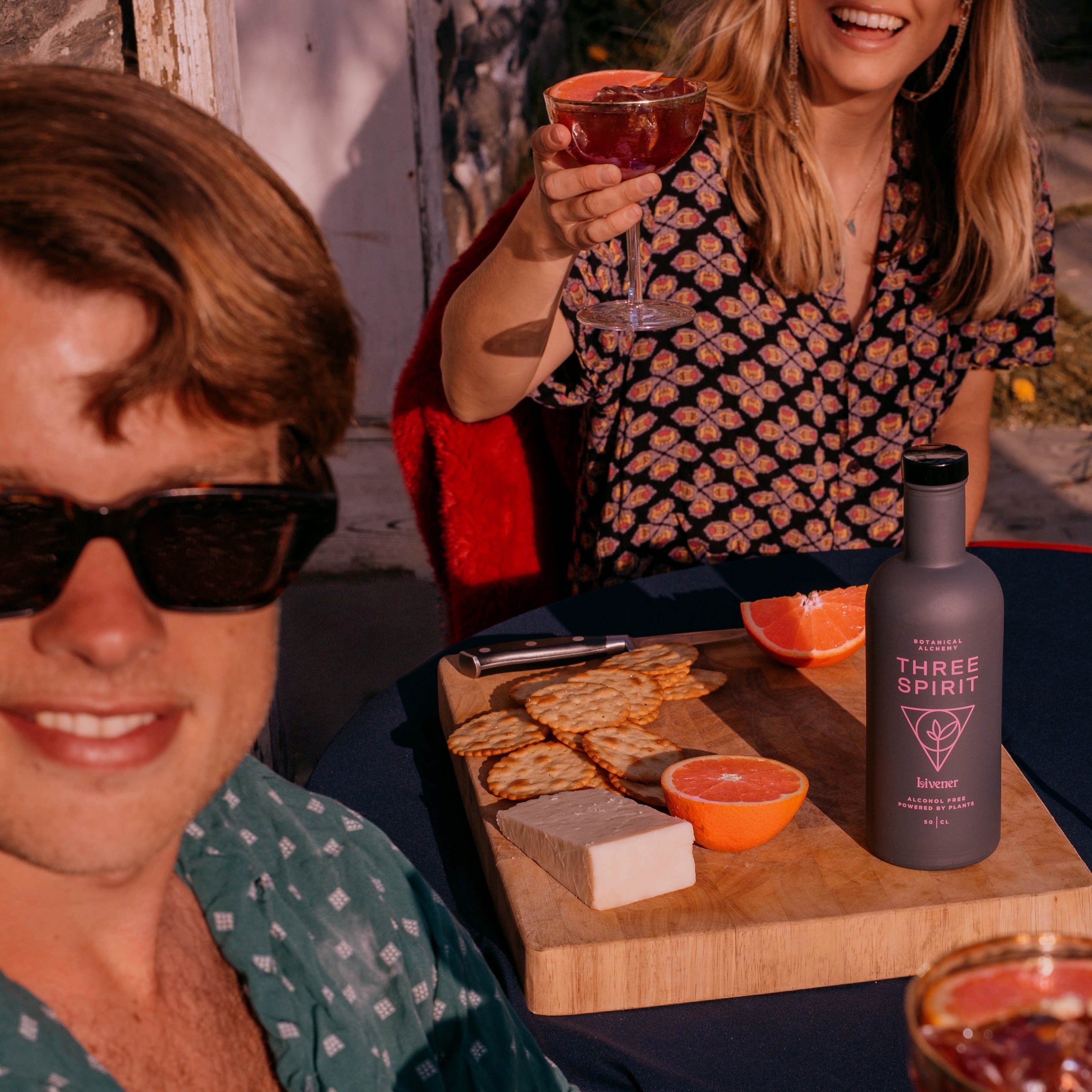 men and woman drinking Three Spirit Livener